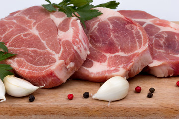 Raw fresh meat on board with condiments