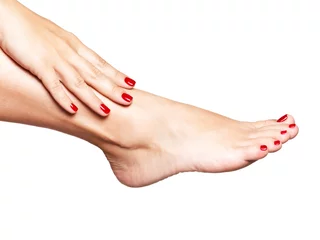 Rolgordijnen Closeup photo of a female feet with beautiful red pedicure © Valua Vitaly