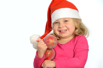 girl with santa cap and christmas tree baubles
