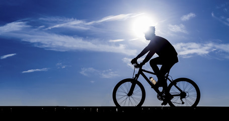 Silhouette of the cyclist riding a road bike