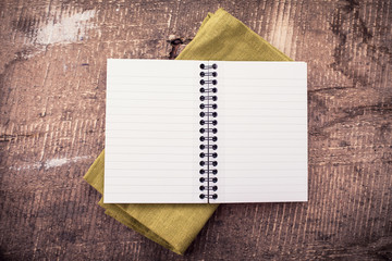 Open empty notebook on wooden background