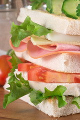 Fresh club sandwich in rustic kitchen setting
