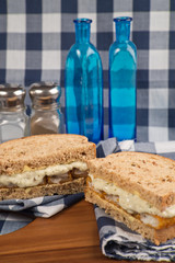 Fresh fish finger sandwich on wholegrain in rustic kitchen setti