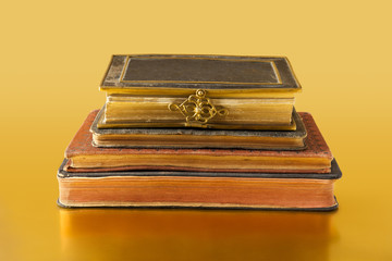 Old books on golden surface