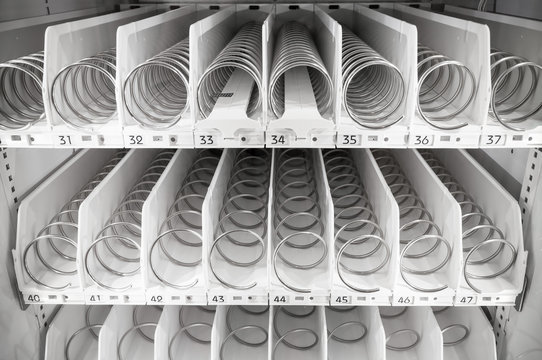 Empty white shelves of standard office vending machine