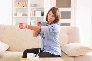 woman checking her blood pressure