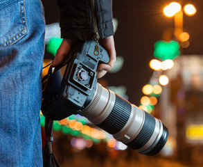 Photographer with camera in the city - obrazy, fototapety, plakaty