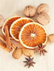 Obraz na płótnie Canvas Dried orange slices with cinnamon and nuts