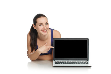 Young girl lying next to laptop