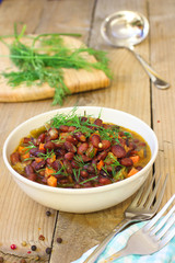 Baked beans with vegetables on wooden rustic table