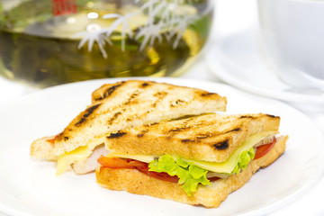 sandwich with tea on a white background in restaurant