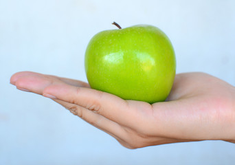 Green Apple in Woman Hand