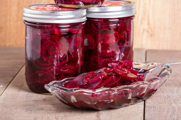 Pickled beets in jars and bowl