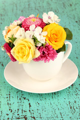 Beautiful bouquet of bright flowers in color vase,