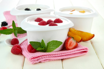 Delicious yogurt with fruit and berries on table close-up