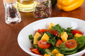 Light salad in plate on wooden table
