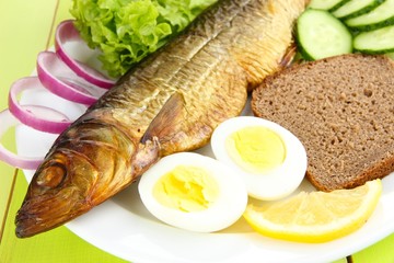 Smoked fish on plate close up