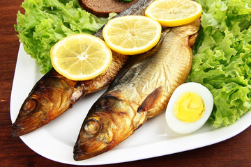 Smoked fish on plate close up
