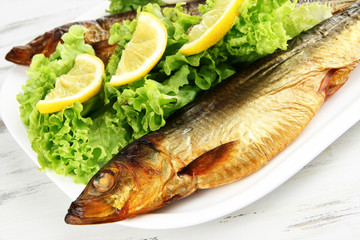 Smoked fish on plate close up