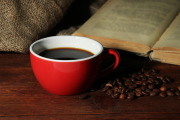 Cup of coffee with coffee beans and book