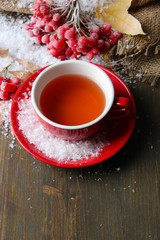 Obraz na płótnie Canvas Still life with viburnum tea in cup, berries and snow,