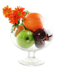 Different fruits and flowers in glass vase isolated on white
