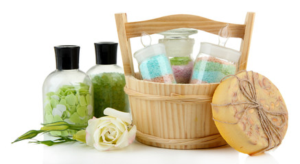 Aromatic salts in glass bottles, in wooden bucket, isolated
