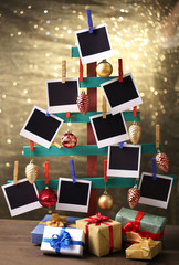 Wooden hand made fir tree with empty photo paper and Christmas