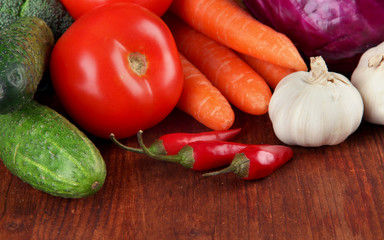 Composition of different vegetables on wooden background