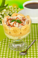 Delicious dessert with banana and caramel on table close-up
