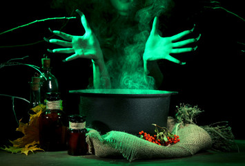 Witch in scary Halloween laboratory on dark color background