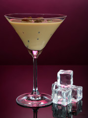 Baileys liqueur in glass on pink background