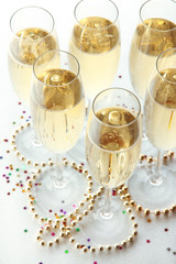 Glasses with champagne on shiny background
