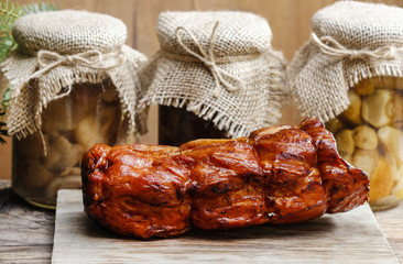Smoked ham and pickled mushrooms on wooden table