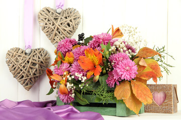 Flowers composition in crate with decorations