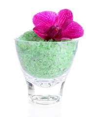 Color sea salt in glass bowl and  orchid flower, isolated