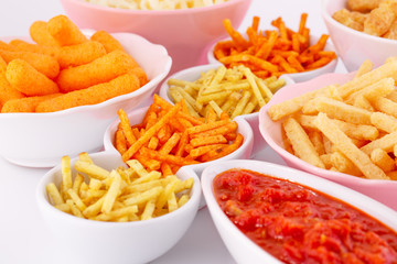 Potato, corn and wheat chips in bowls