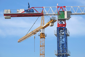 Closeup Of Tower Cranes At A Construction Site