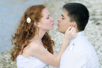 beautiful young couple in love near the sea