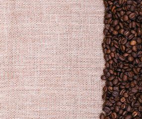 Coffee beans on burlap background