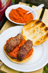 Cevapcici with ajvar in the grilled roll