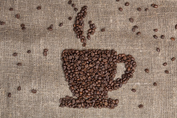 coffee beans shaping cup on burlap