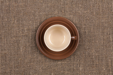 top of  Brown coffee cup  on burlap