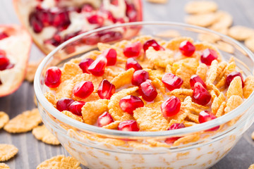 Sugar coated corn flakes with milk and pomegranate