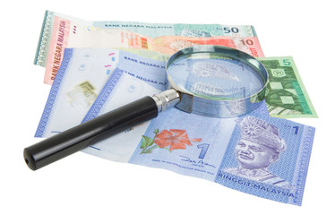 Malaysia bank notes money with magnifying glass
