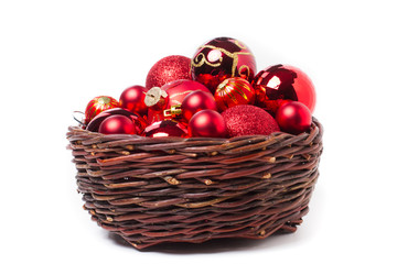 Red christmas baubles in wicker basket