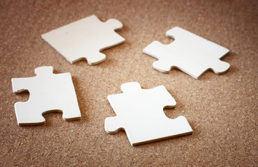 puzzle pieces on wooden background