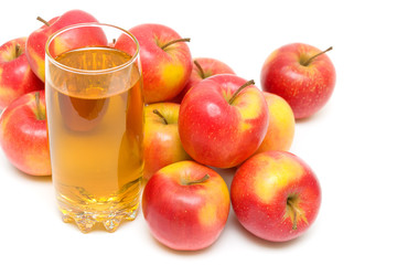 ripe red apples and glass with juice close up on a white backgro