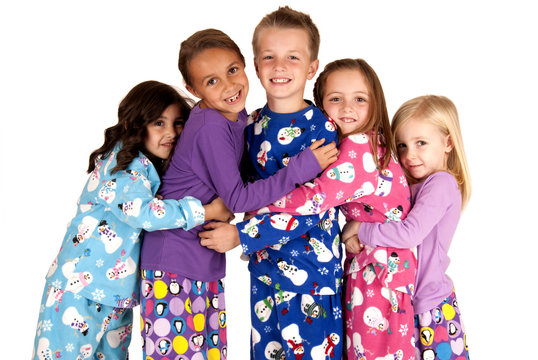 children hugging in holiday christmas pajamas