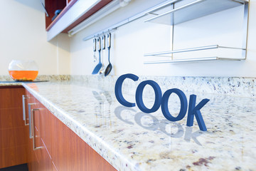 Modern white kitchen with cook sign